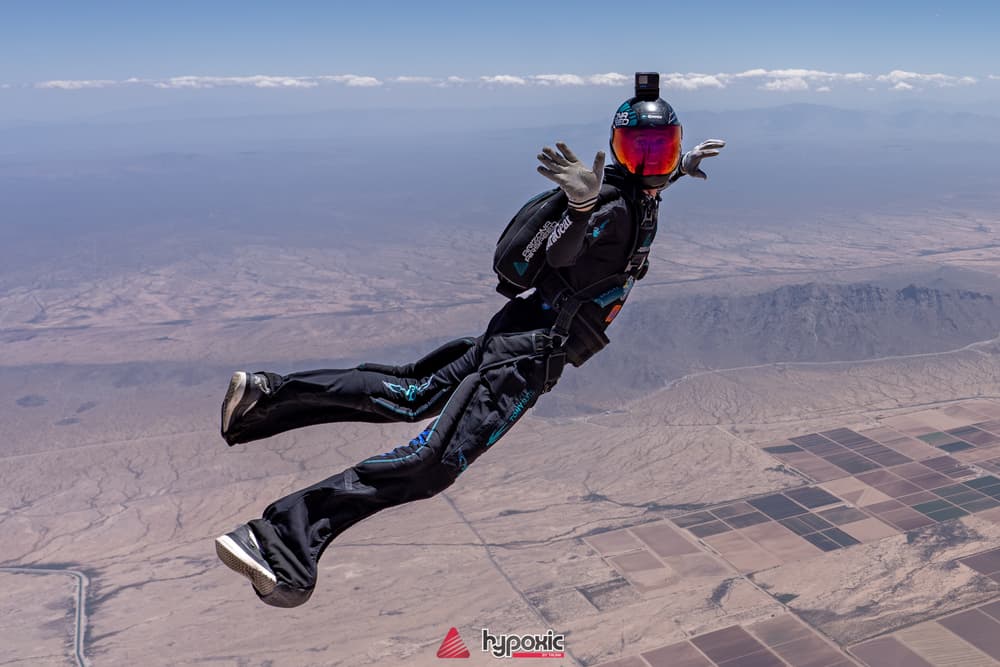 A solo skydiver flying above the Arizona desert