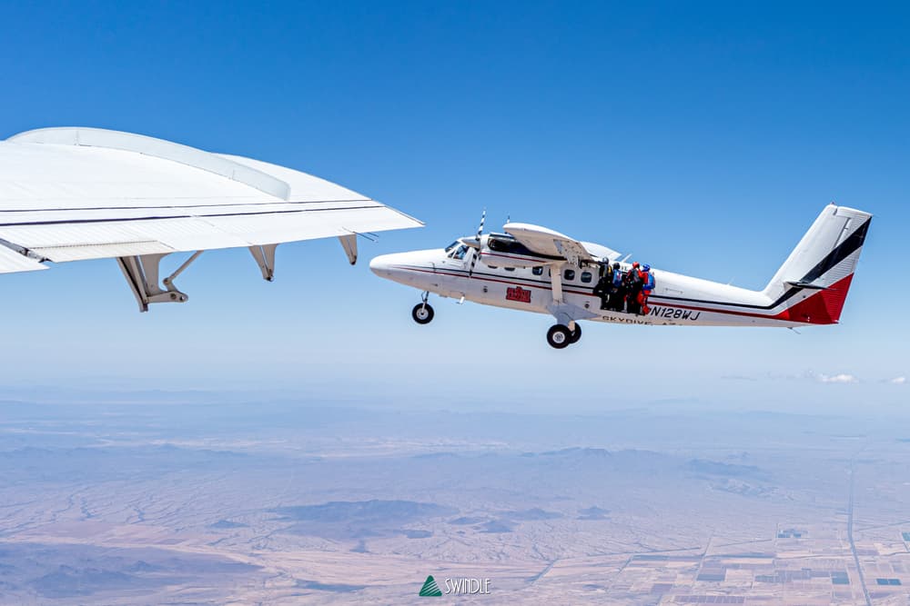 A jump plane flying above the Arizona landscape